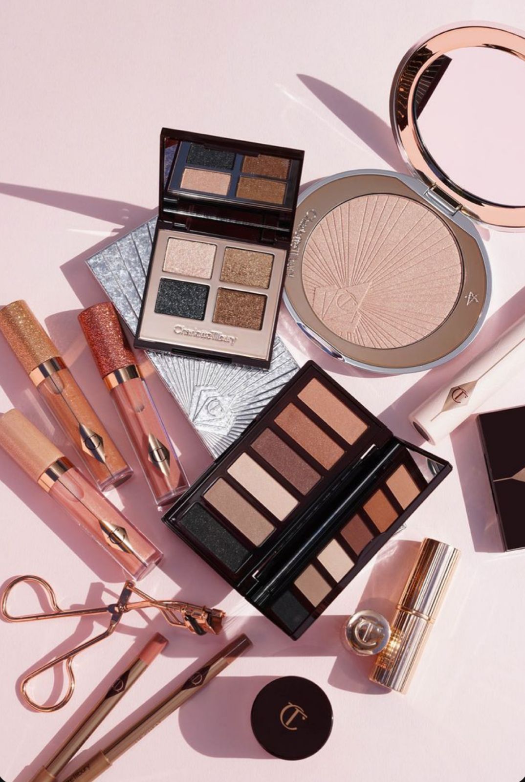 This is makeup kit, featuring eyeshadow palettes, highlighter, and some beauty tools.